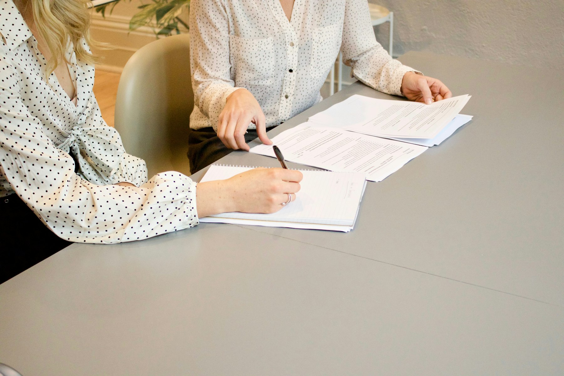 Business documents being reviewed and signed during negotiation